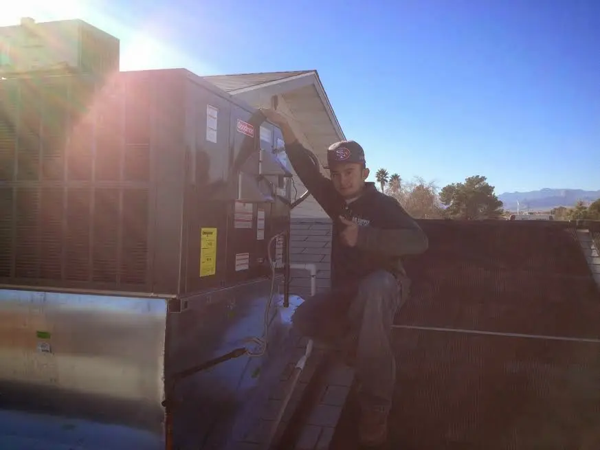 HVAC technician performing Heat Pump Repair on a rooftop unit in Crawfordville